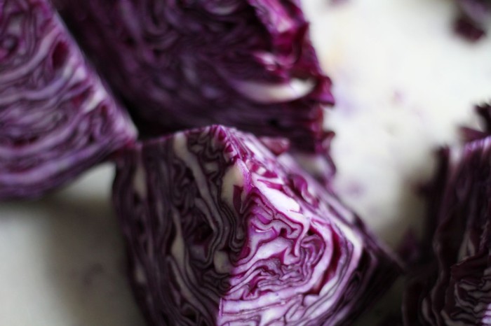 Red cabbage tends to be tightly packed and have harder, crisper leaves.  It generally takes a bit longer to ferment than green cabbage.
