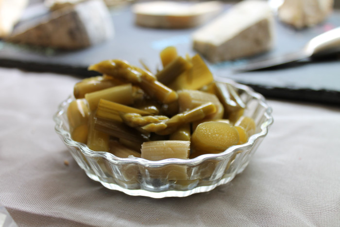Asparagus pickles in front of a cheese board